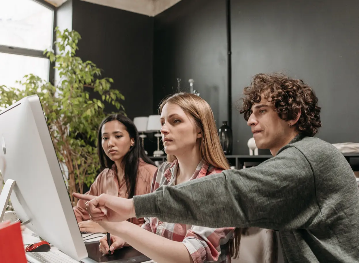 A group of three people who are the employee of Webmark8 it is Website design company in aligrah who provide a website design service in aligarh area three of them working on designing a website in aligarh area